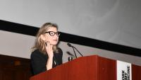 Dr. Catherine Monk speaking at a podium.